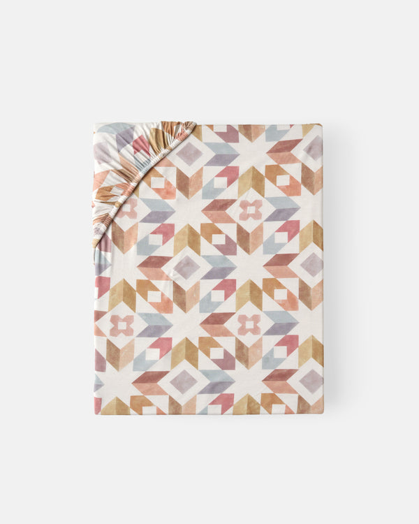 Flat lay of the Kaleidoscope Dreams Fitted Crib Sheet