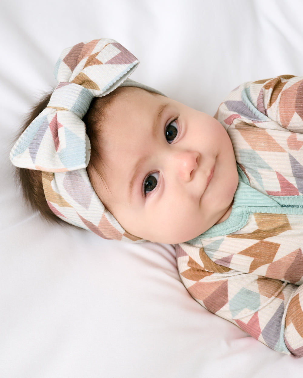 Close up of newborn wearing the Kaleidoscope Dreams Ribbed Luxe Bow Headband
