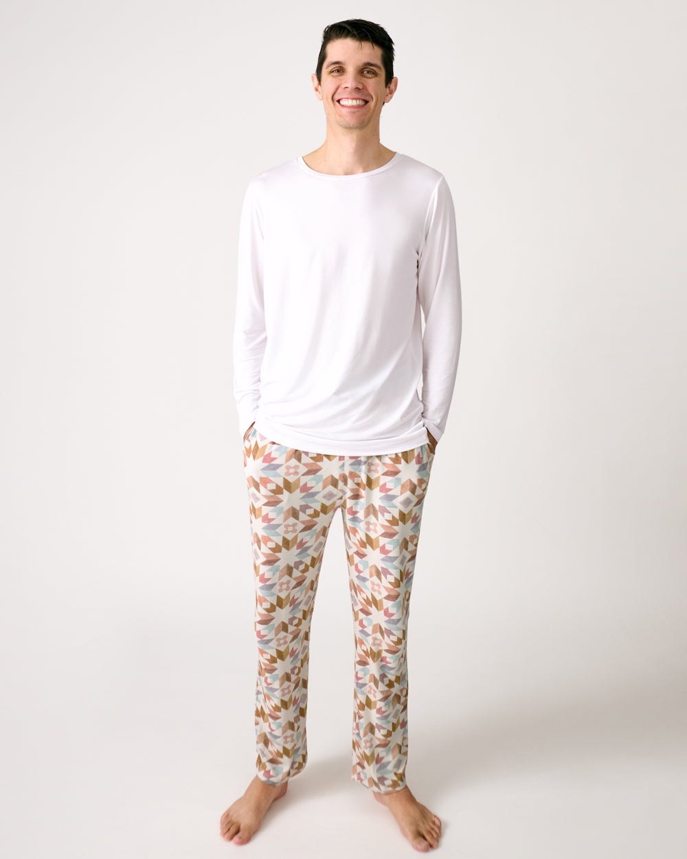 Standing man wearing the Kaleidoscope Dreams Ribbed Men's Pajama Pants with a white top