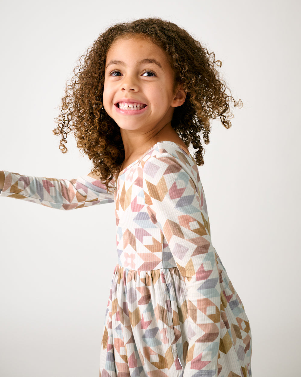 Child in motion wearing the Kaleidoscope Dreams Ribbed Skater Dress