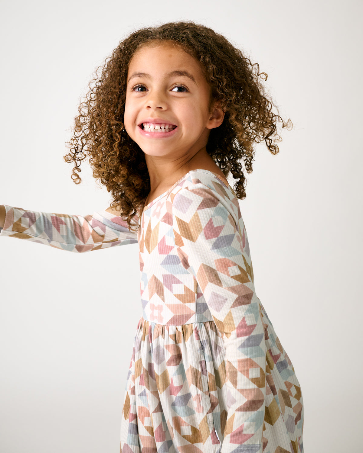 Child in motion wearing the Kaleidoscope Dreams Ribbed Skater Dress