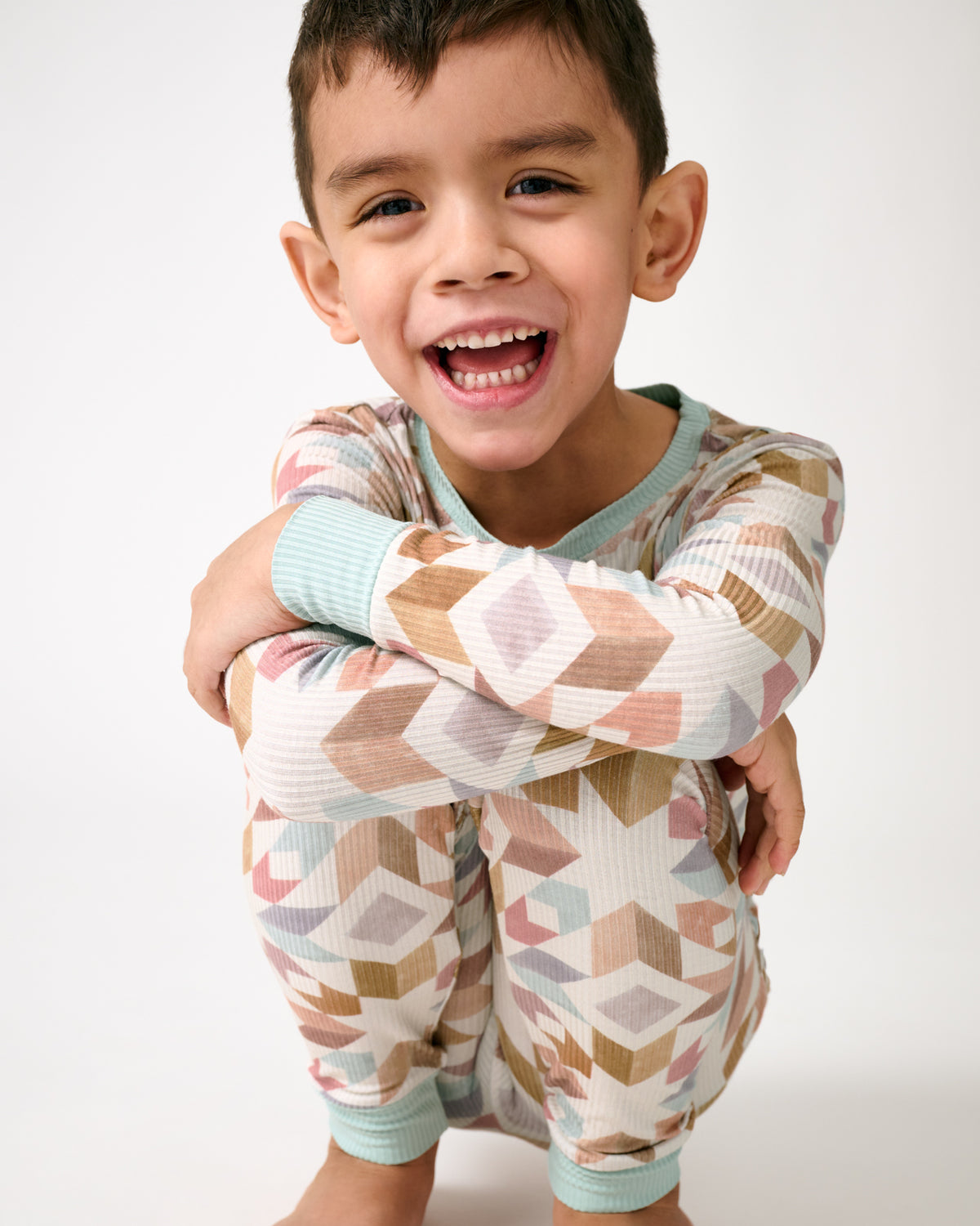 Crouching boy wearing the Kaleidoscope Dreams Ribbed Two-Piece Pajama Set
