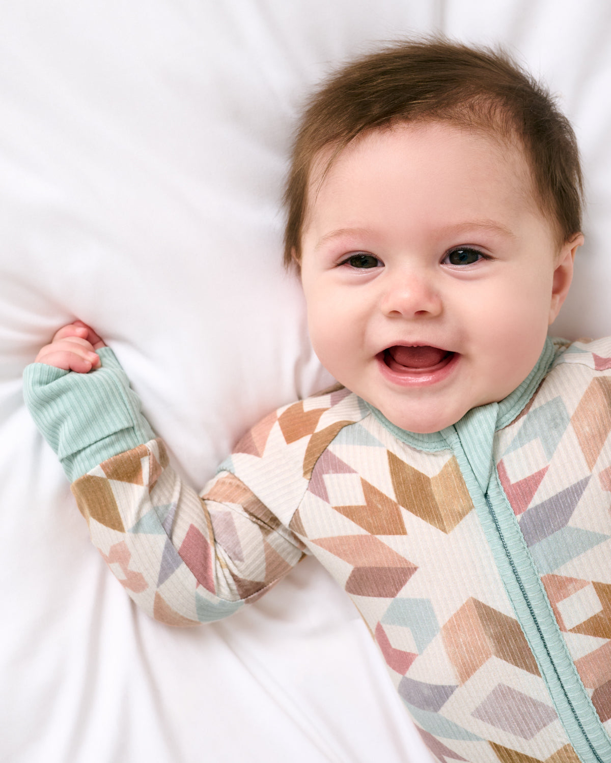 Close up of baby wearing the Kaleidoscope Dreams Ribbed Zippy