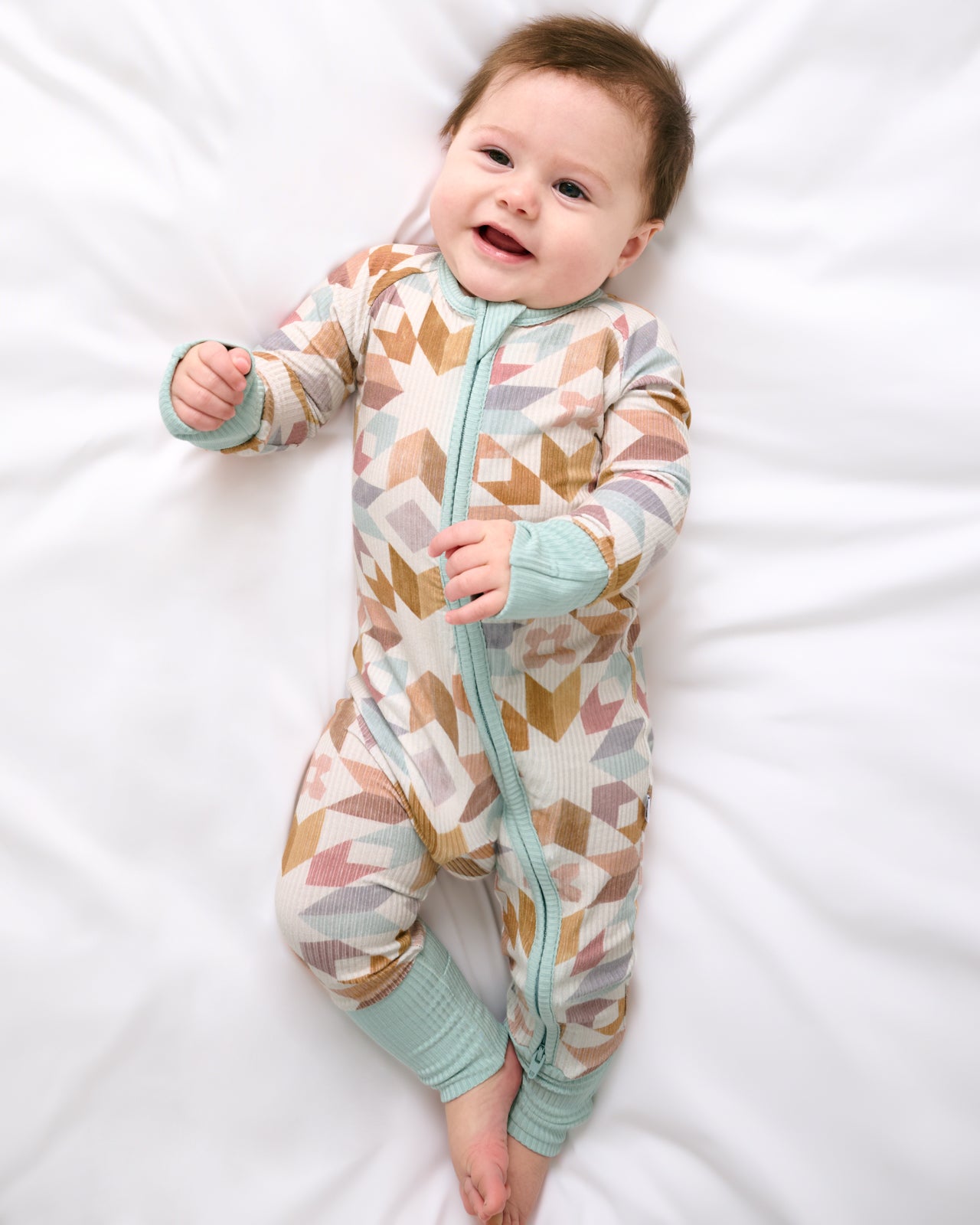 Aerial view of baby wearing the Kaleidoscope Dreams Ribbed Zippy