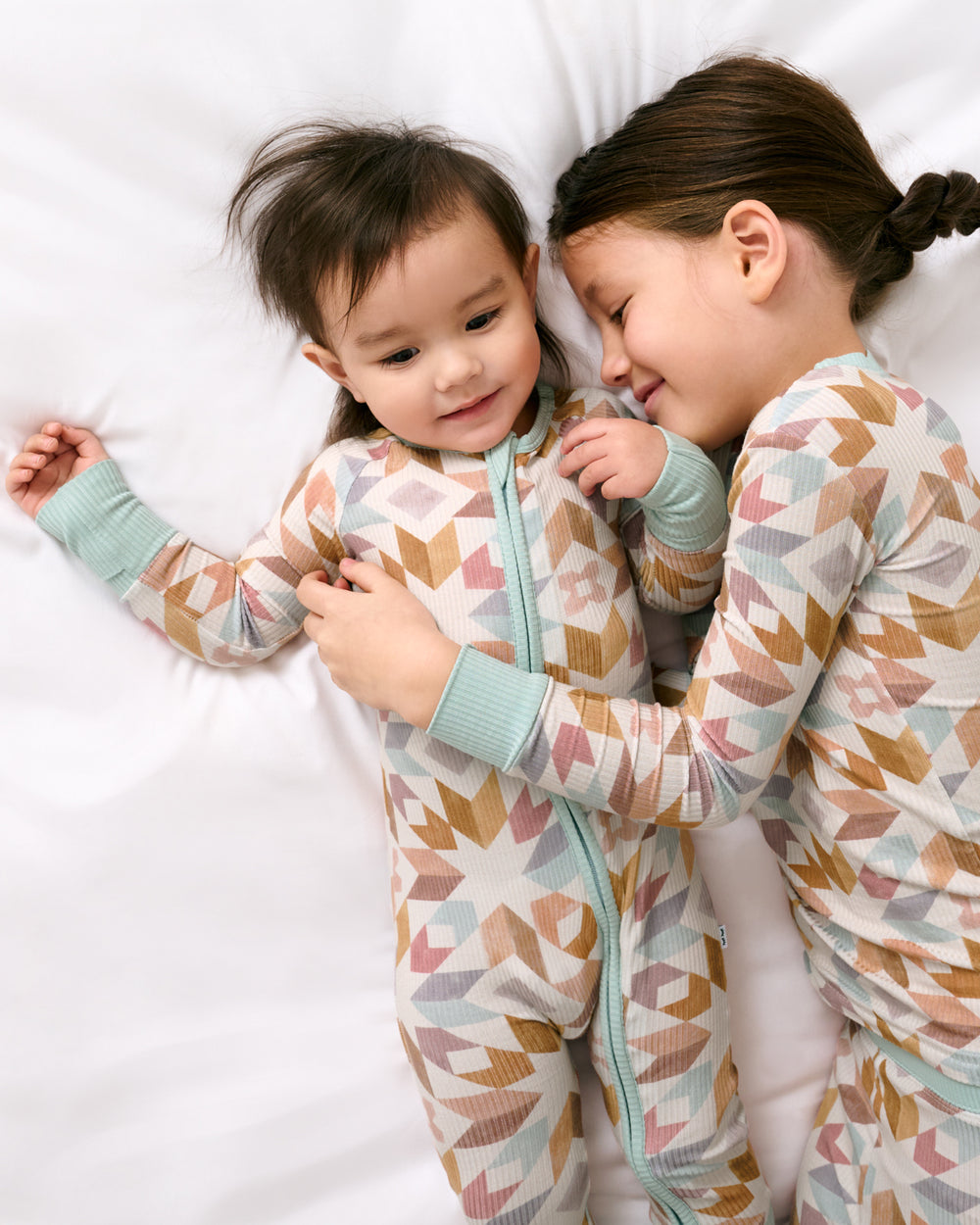 Two siblings wearing matching Kaleidoscope Dreams Ribbed Pajamas
