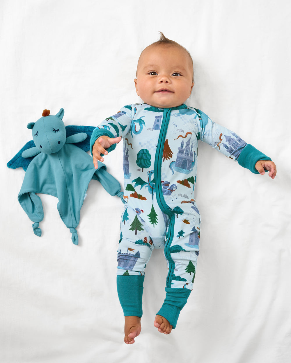 Aerial view of baby laying with the Spark the Dragon Sleepyhead Lovey