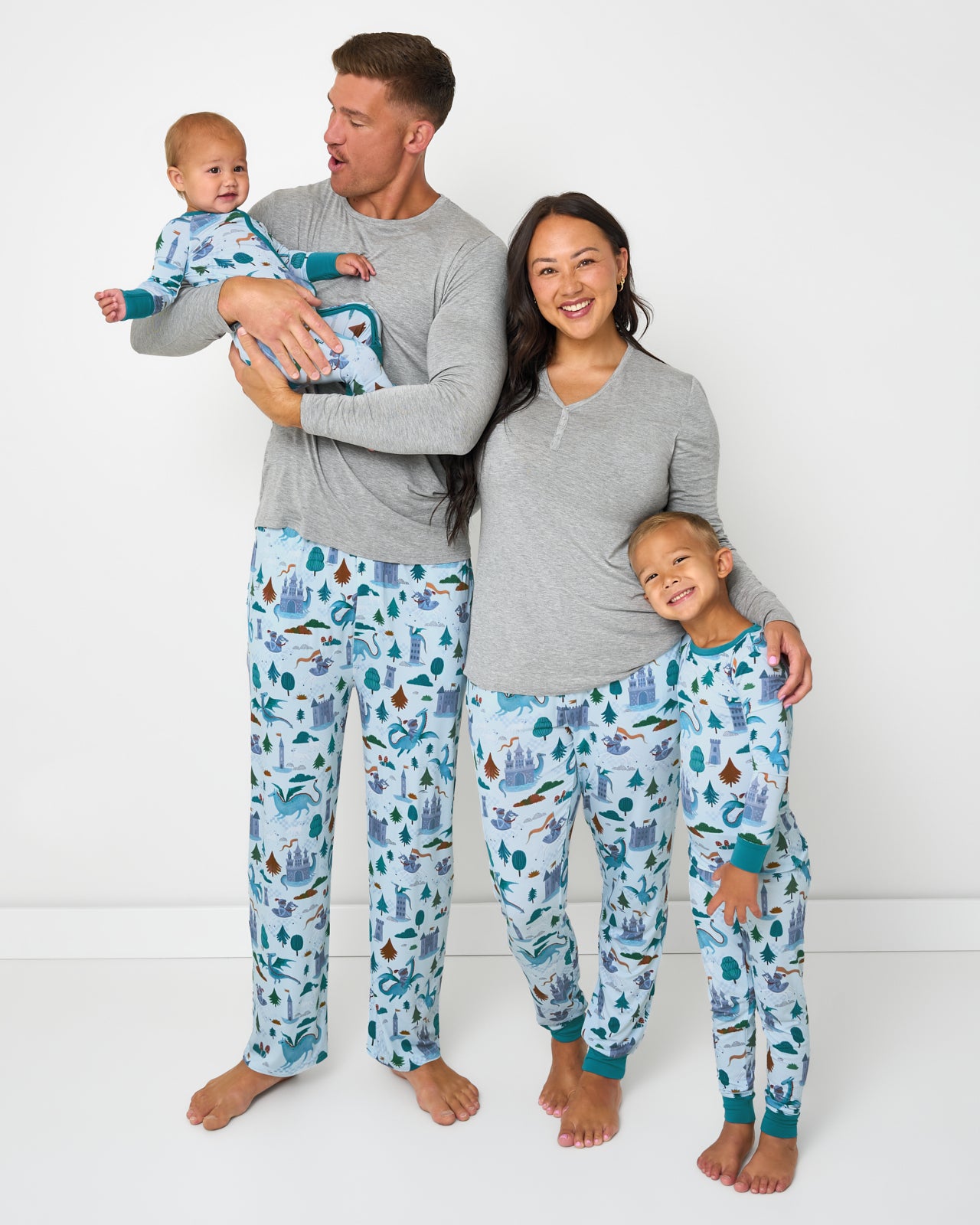 Family of four wearing matching Knight's Quest bamboo pajamas