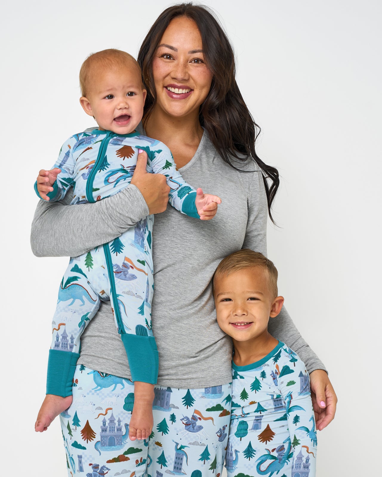 Mother and two children wearing matching Knight's Quest pajamas