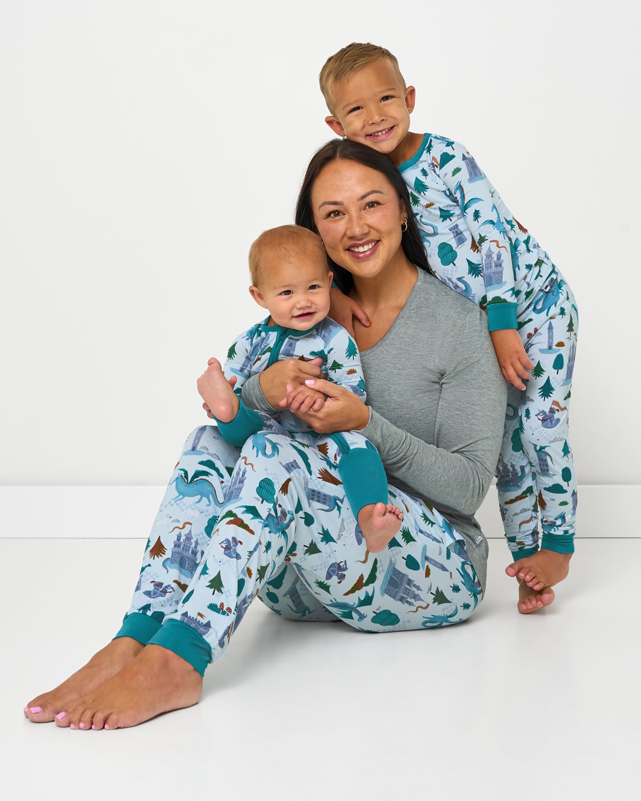 Mother and two children wearing matching Knight's Quest bamboo pajamas