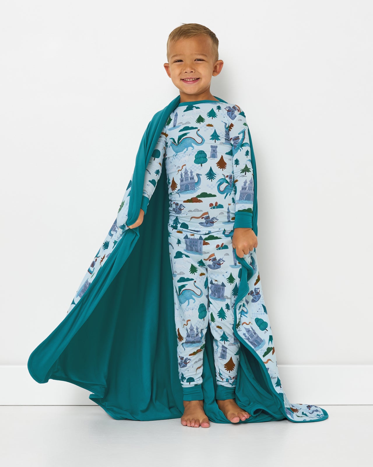 Standing boy wrapped in the Knight's Quest Large Cloud Blanket®
