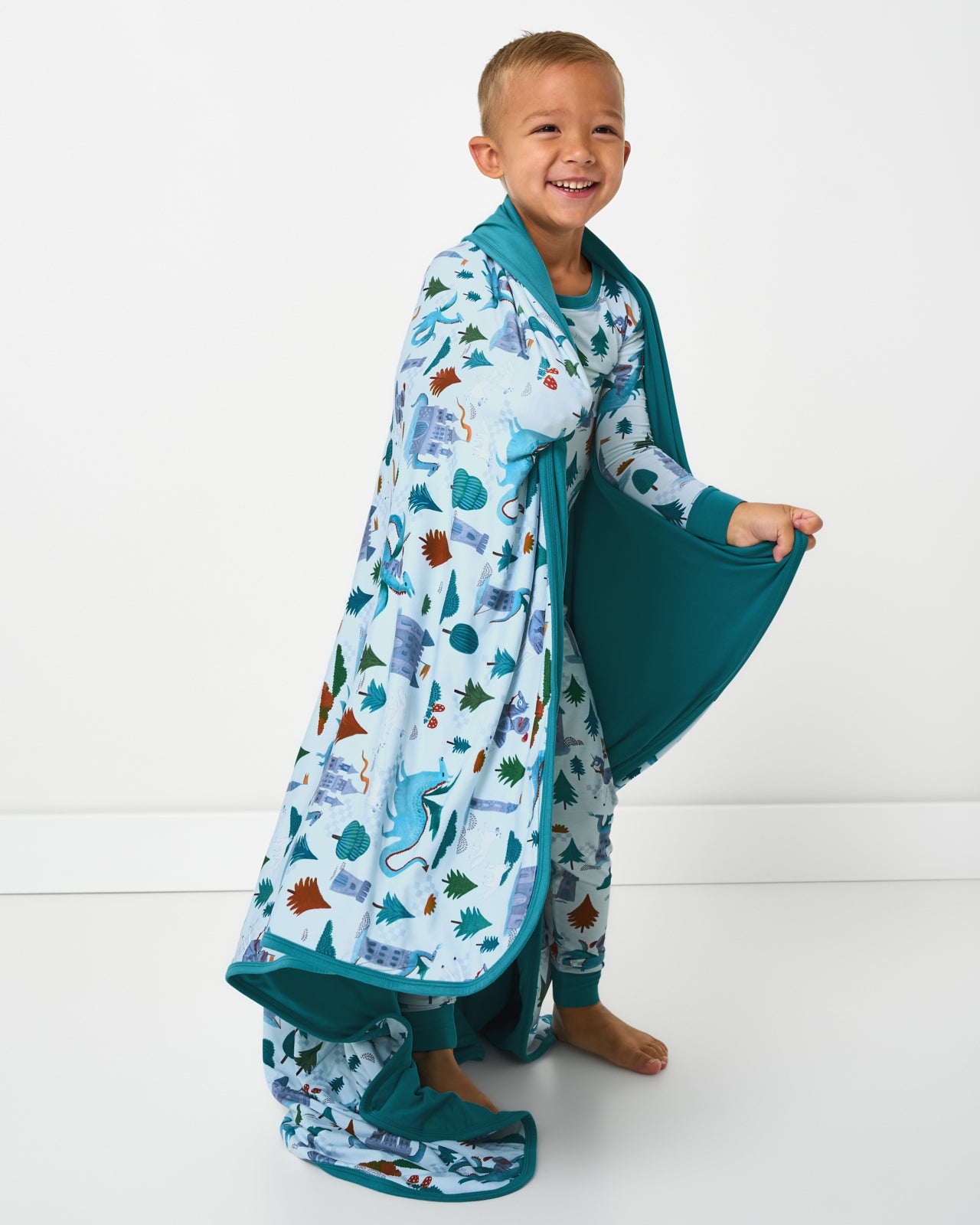 Standing boy wrapped in the Knight's Quest Large Cloud Blanket®