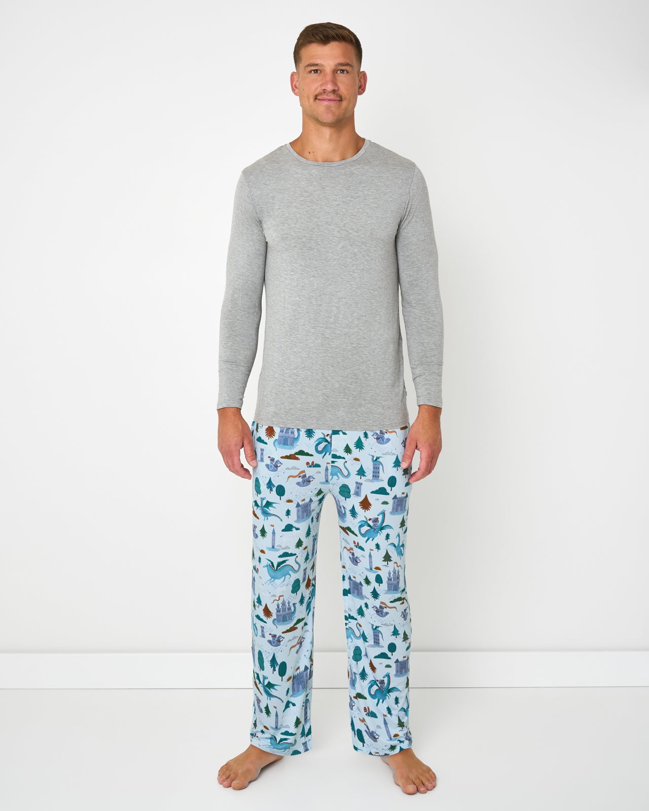 Man wearing the Knight's Quest Men's Pajama Pants with a gray pajama top