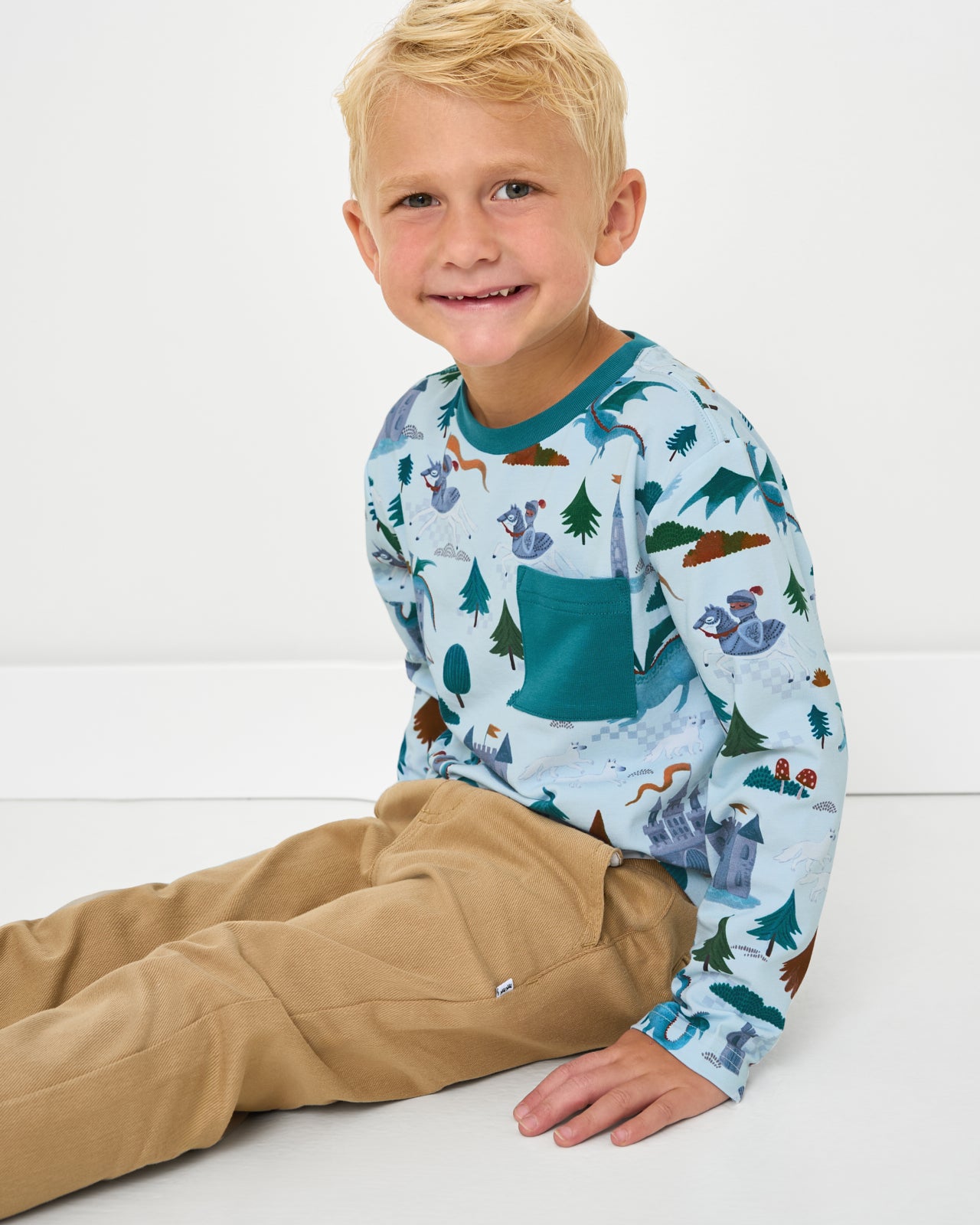 Sitting boy wearing the Knight's Quest Relaxed Pocket Tee