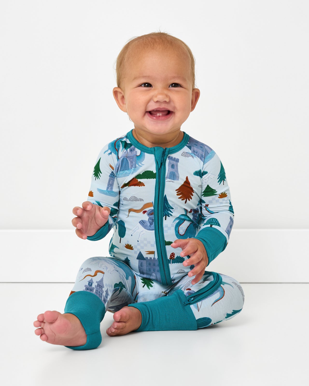 Sitting baby wearing the Knight's Quest Zippy