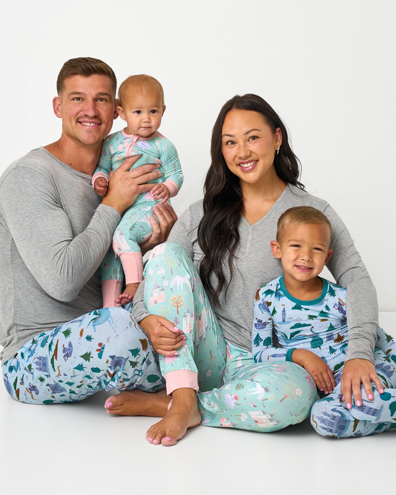 Family of four wearing Enchanted Fairytale and Knights Quest pajamas