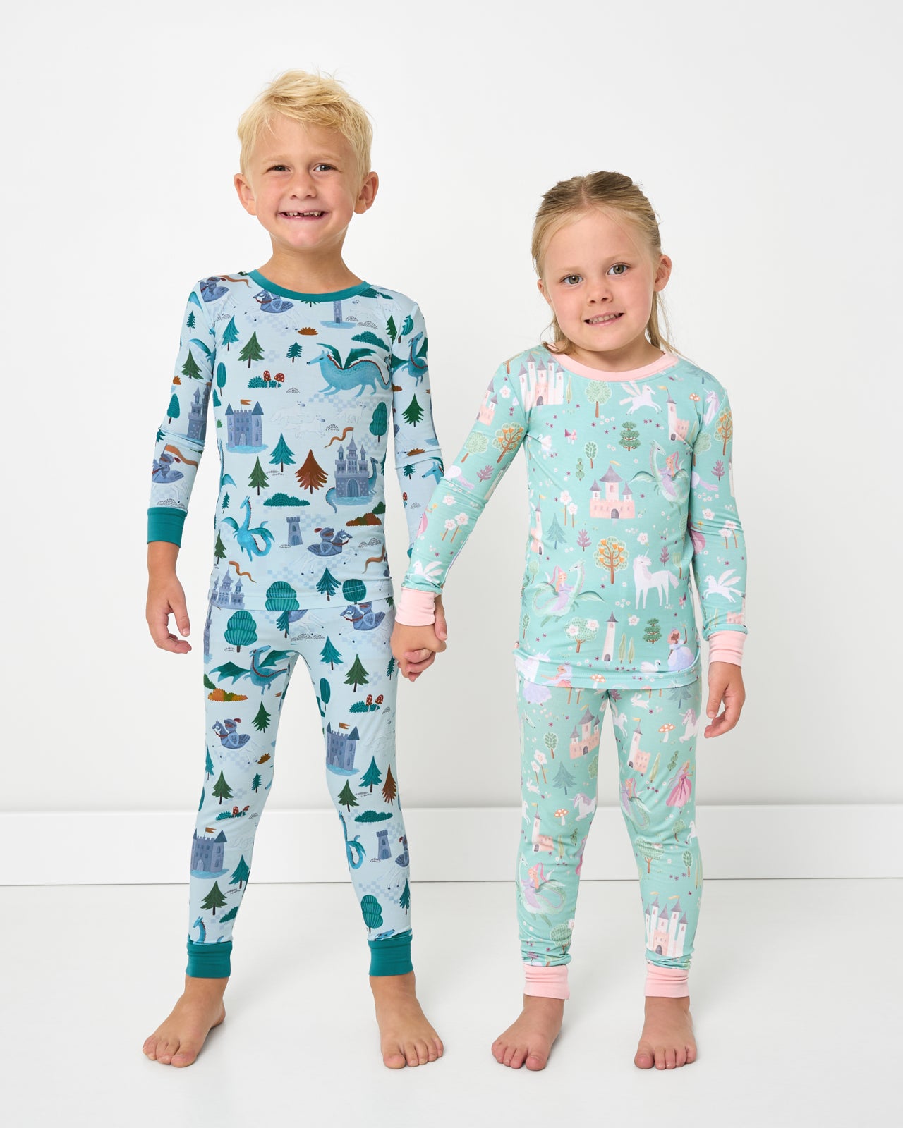 Two children wearing matching Knight's Quest and Enchanted Fairytale Two-Piece Pajama Sets