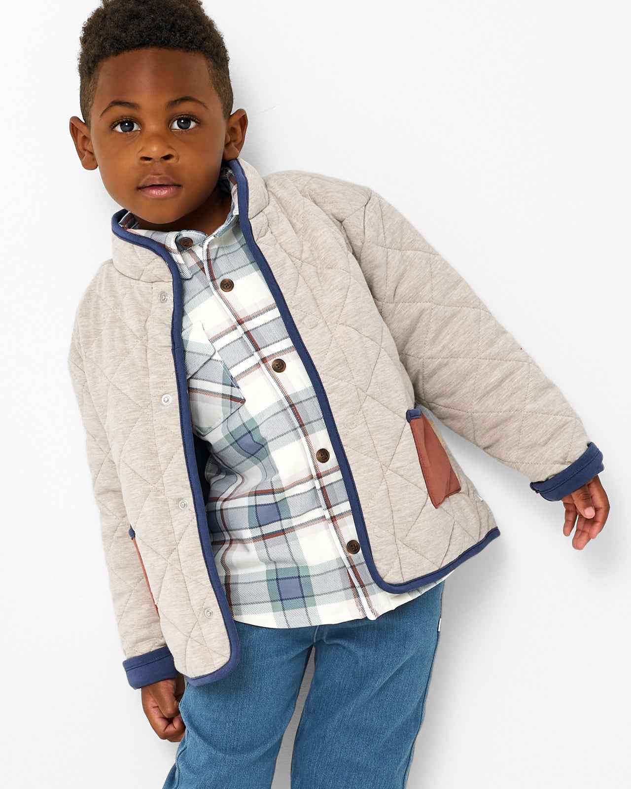 Boy wearing the Linen Heather Quilted Barn Jacket layered over a plaid shacket