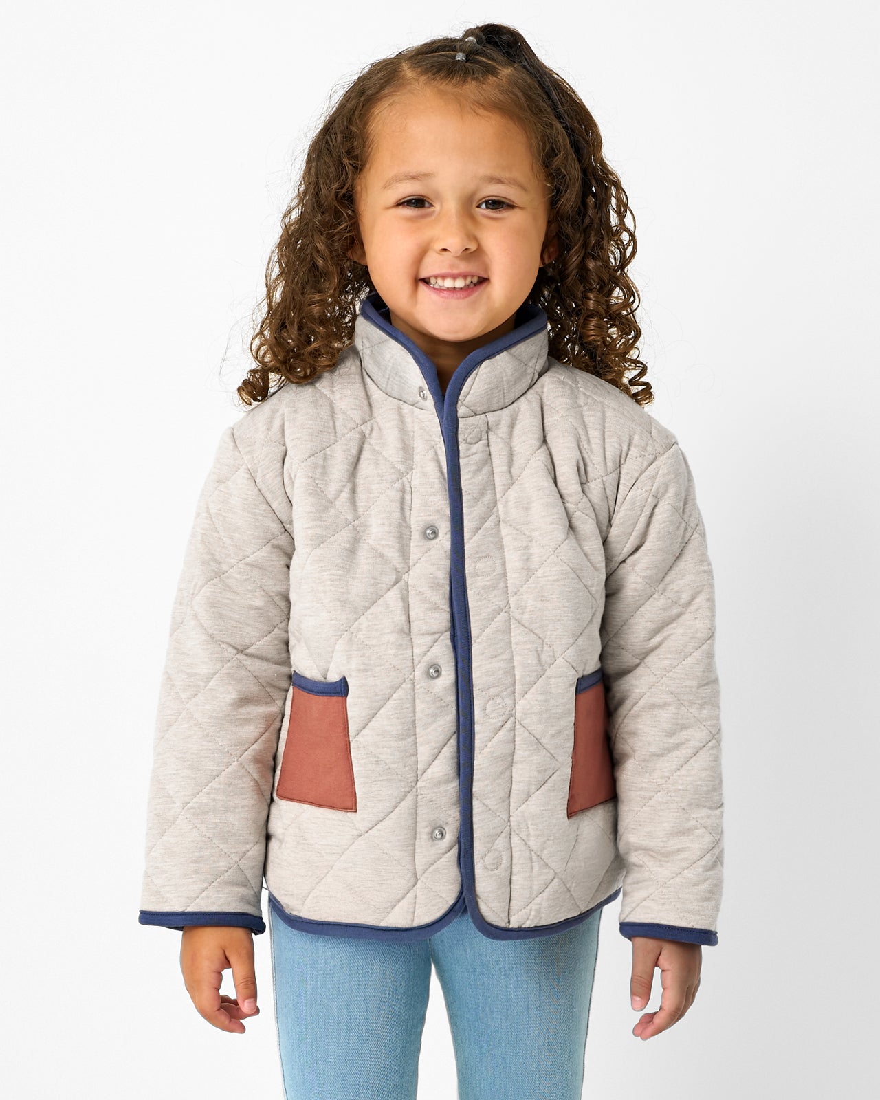 Girl wearing the Linen Heather Quilted Barn Jacket with denim pants