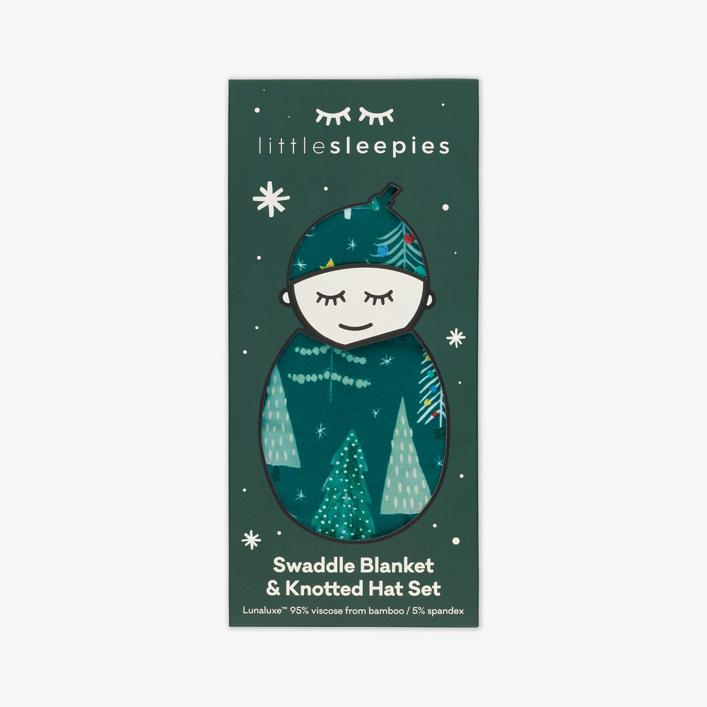 Image of packaging for the Green Twinkling Trees Swaddle & Hat Set