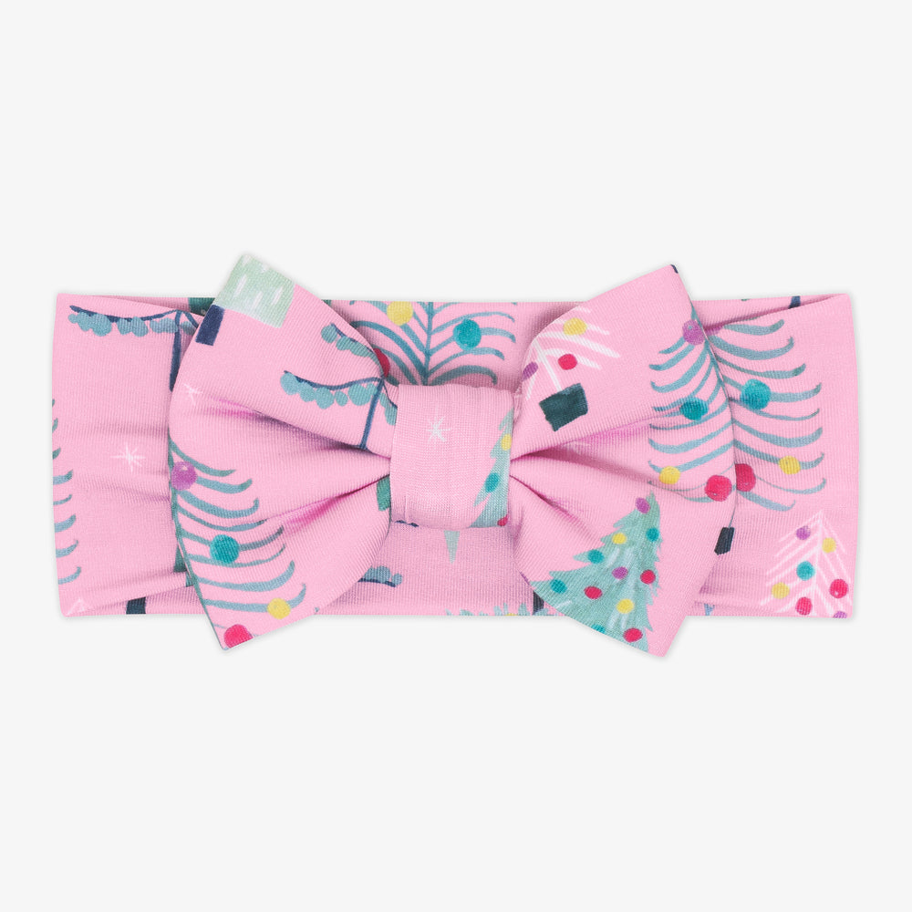 Flat lay image of a Pink Twinkling Trees Luxe Bow Headband