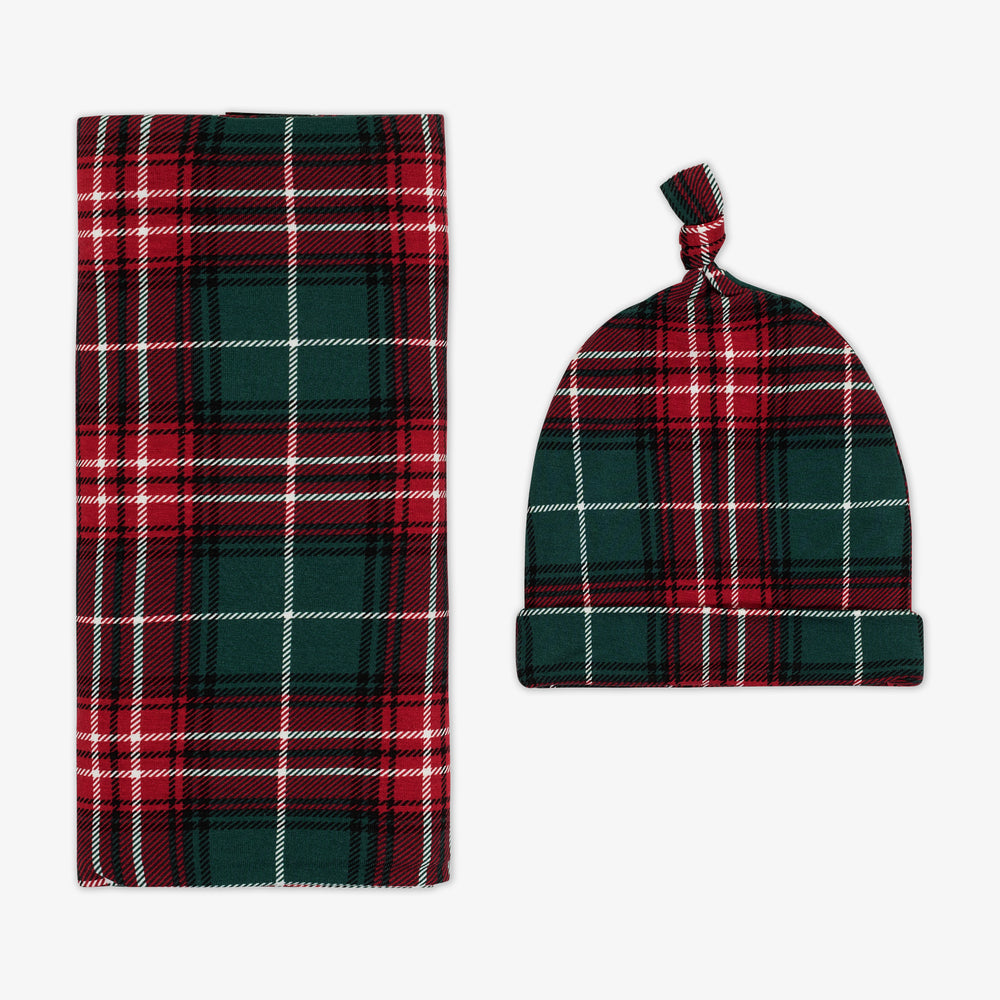 Flat lay image of a Fireside Plaid Swaddle & Hat Set