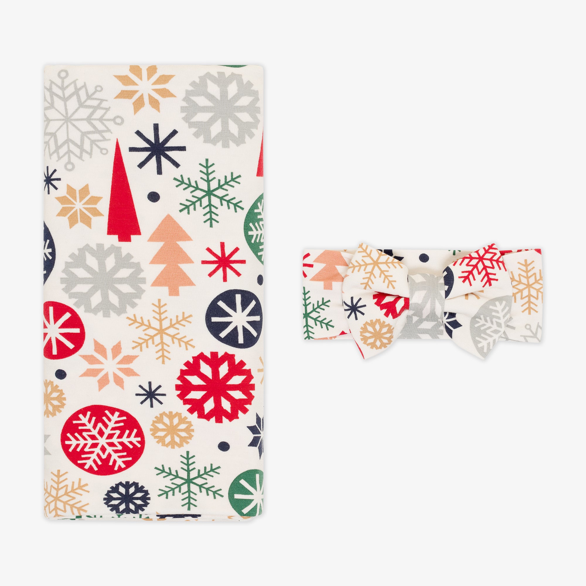 Flat lay image of the Modern & Merry Swaddle & Luxe Bow Headband Set