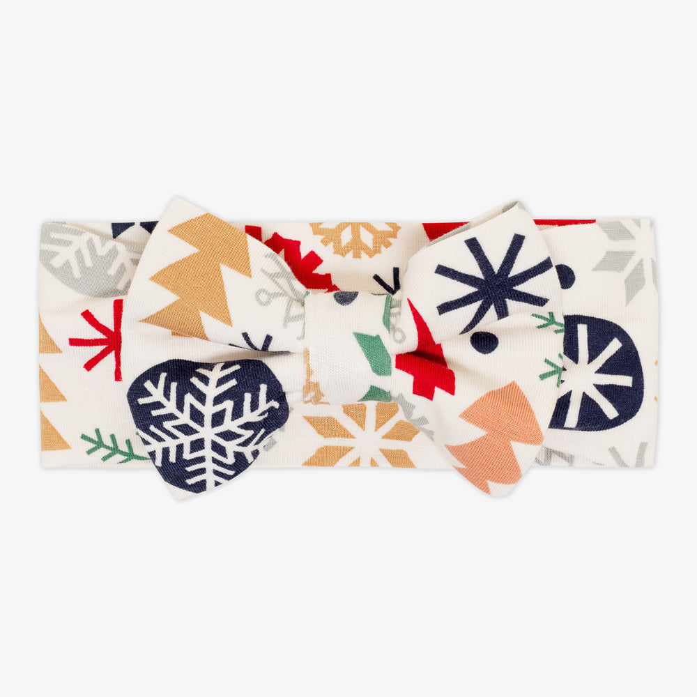 Flat lay image of the Modern & Merry Luxe Bow Headband