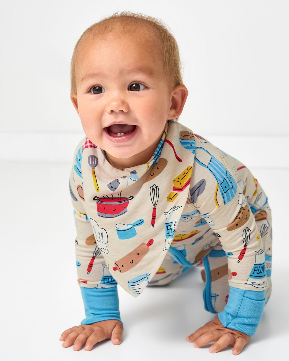 Crawling baby wearing the Little Chef Bandana Bib