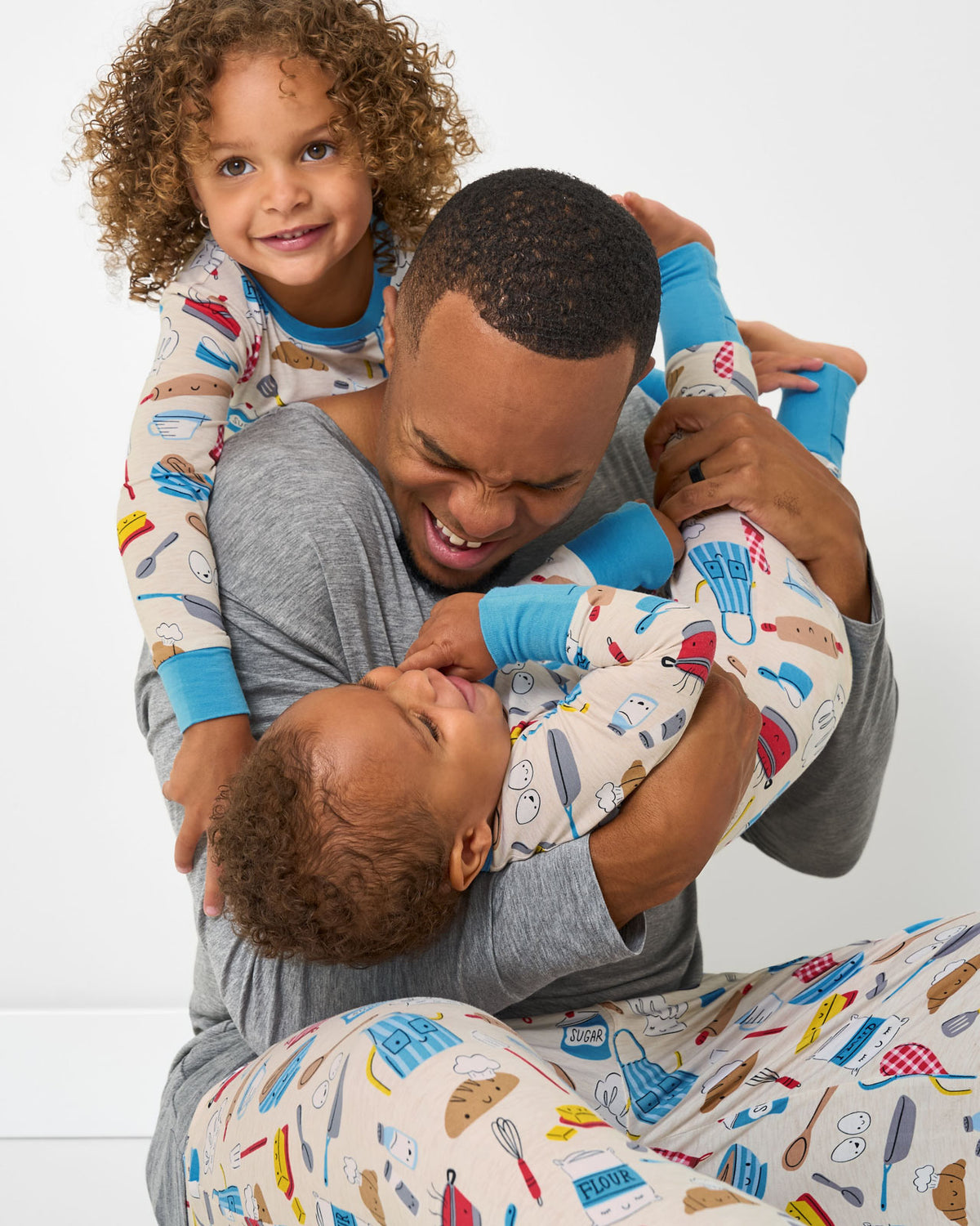 Father and two children wearing matching Little Chef pajamas