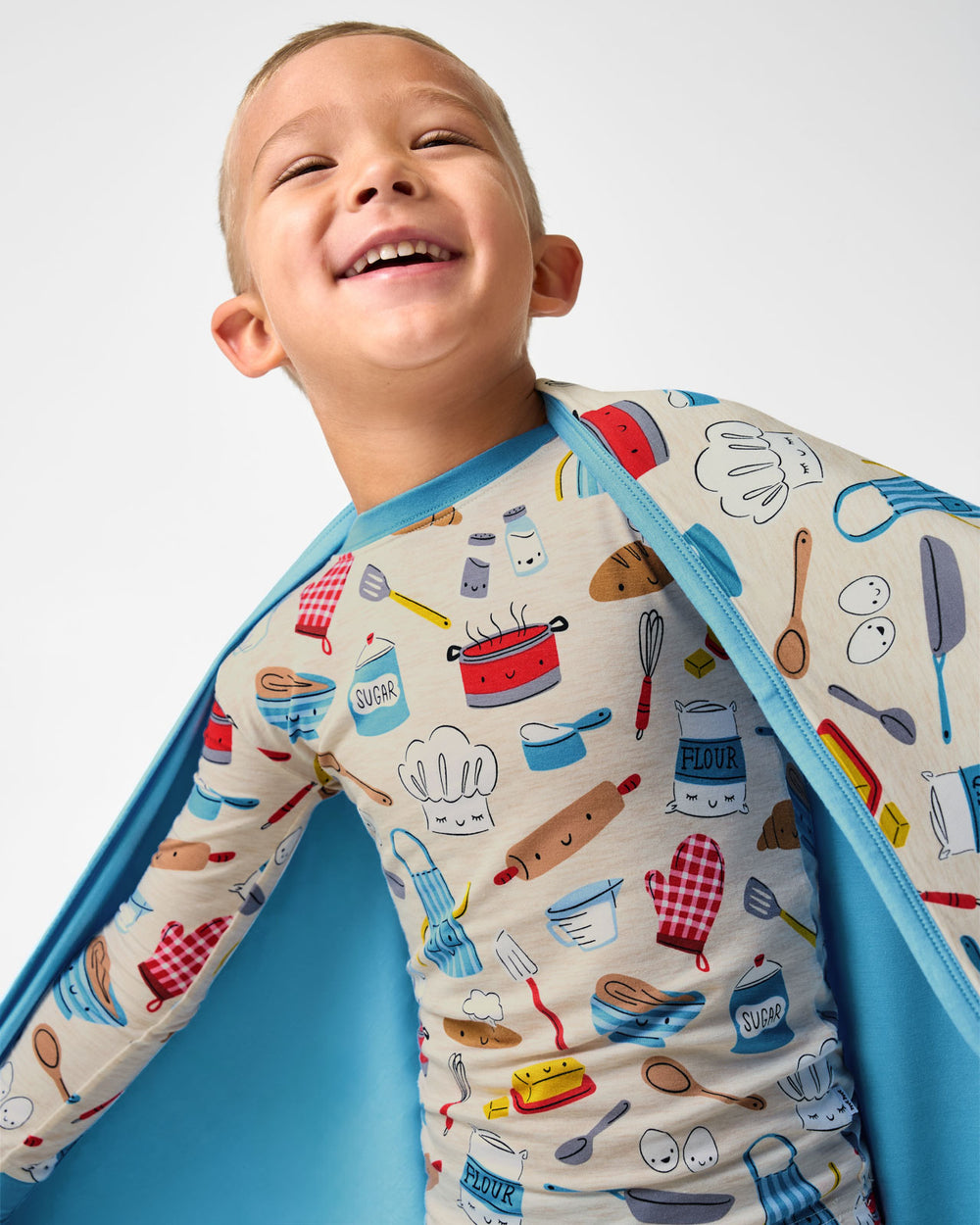 Close up of boy wrapped in the Little Chef Large Cloud Blanket®
