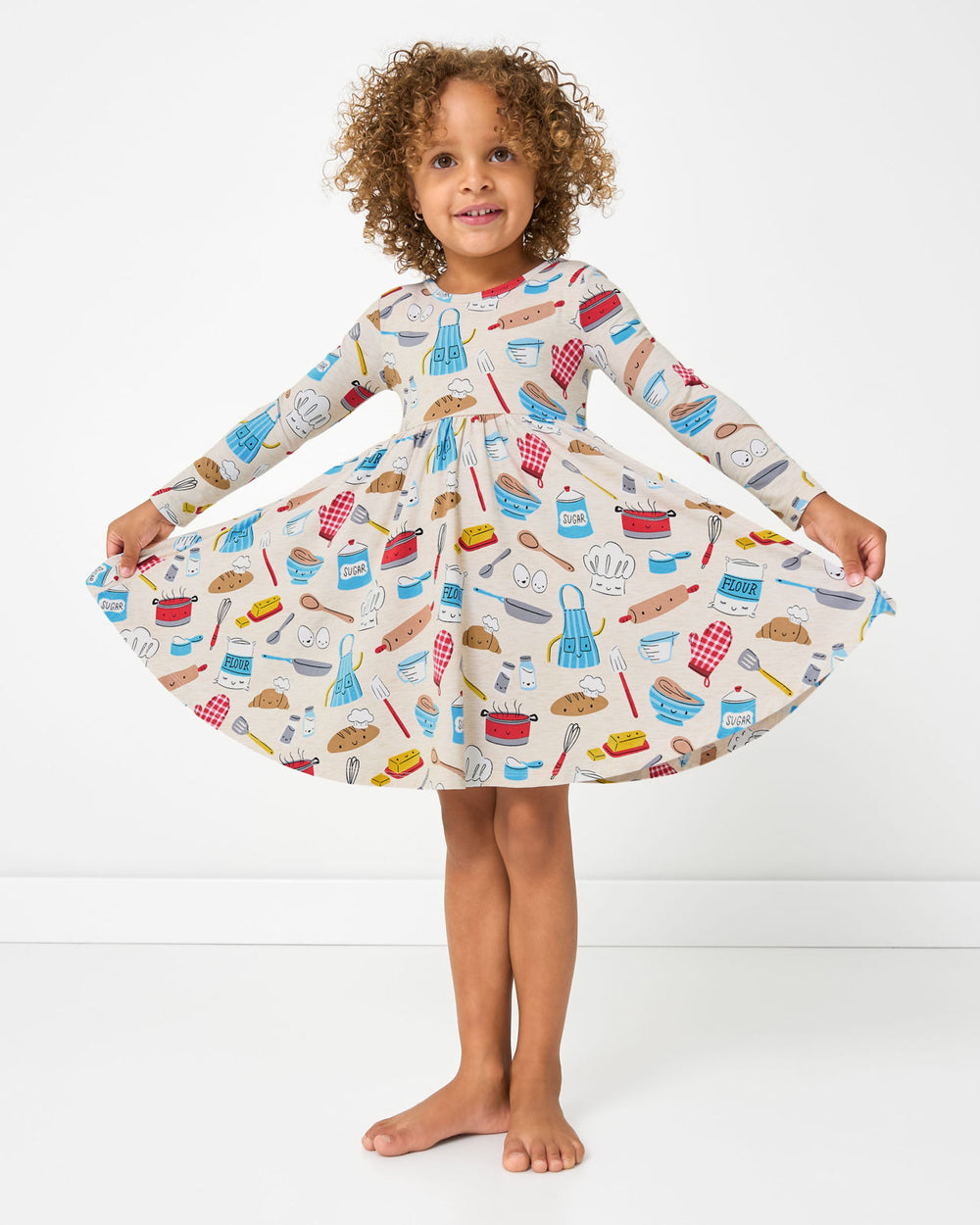 Standing girl wearing the Little Chef Twirl Dress