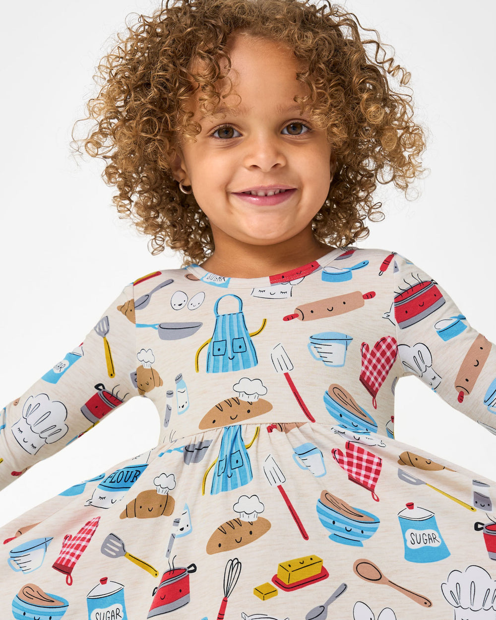 Close up of girl wearing the Little Chef Twirl Dress