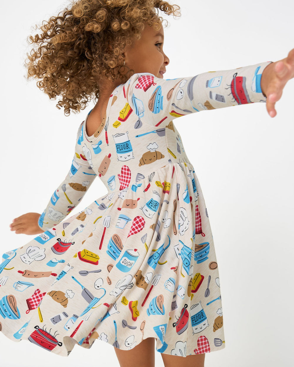 Twirling girl wearing the Little Chef Twirl Dress