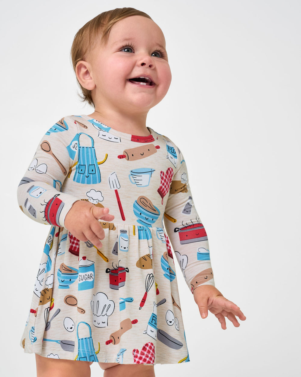 Close up of baby wearing the Little Chef Twirl Dress with Bodysuit