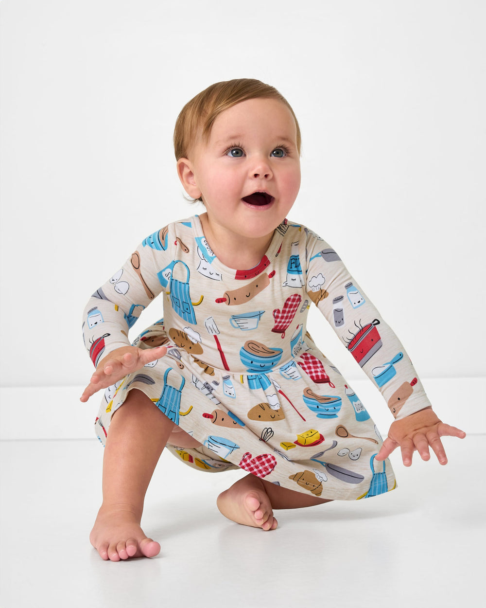 Child in motion wearing the Little Chef Twirl Dress with Bodysuit