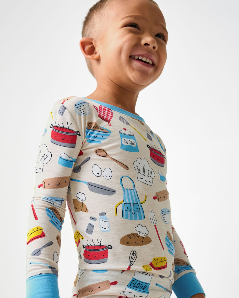 Close up of boy wearing the Little Chef Two-Piece Pajama Set