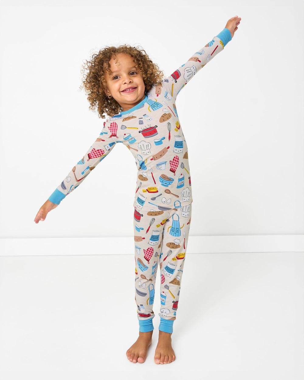 Posing girl wearing the Little Chef Two-Piece Pajama Set