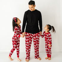 Father and two children wearing matching Love Bug printed pajamas