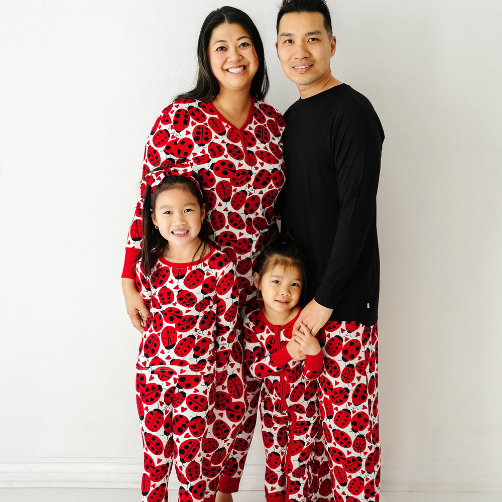 Family of four wearing matching Love Bug pajamas