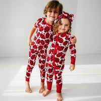 Two children wearing matching Love Bug printed pajamas