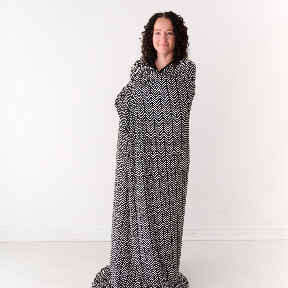 Woman wrapped up in a Monochrome Chevron oversized cloud blanket
