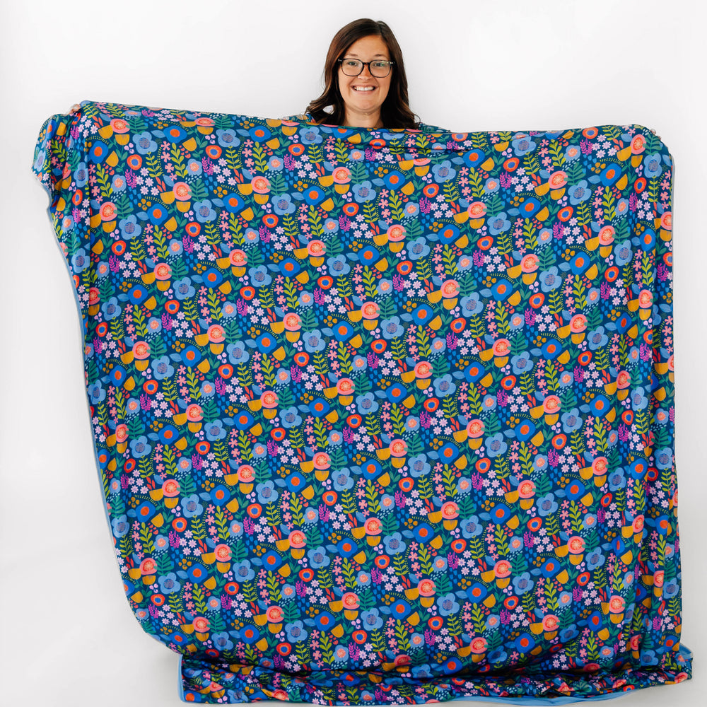 Woman holding the Folk Floral Oversized Cloud Blanket®