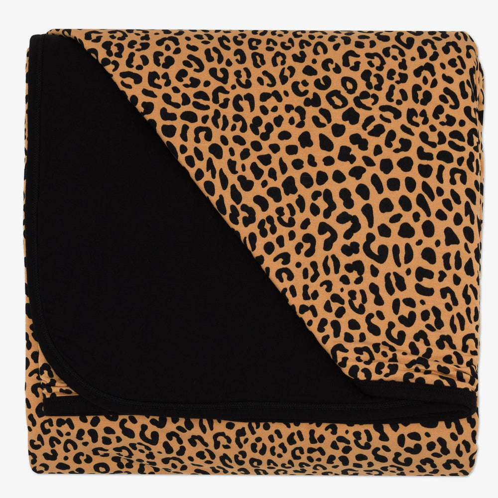 Flat lay image of the Classic Leopard Oversized Cloud Blanket® folded