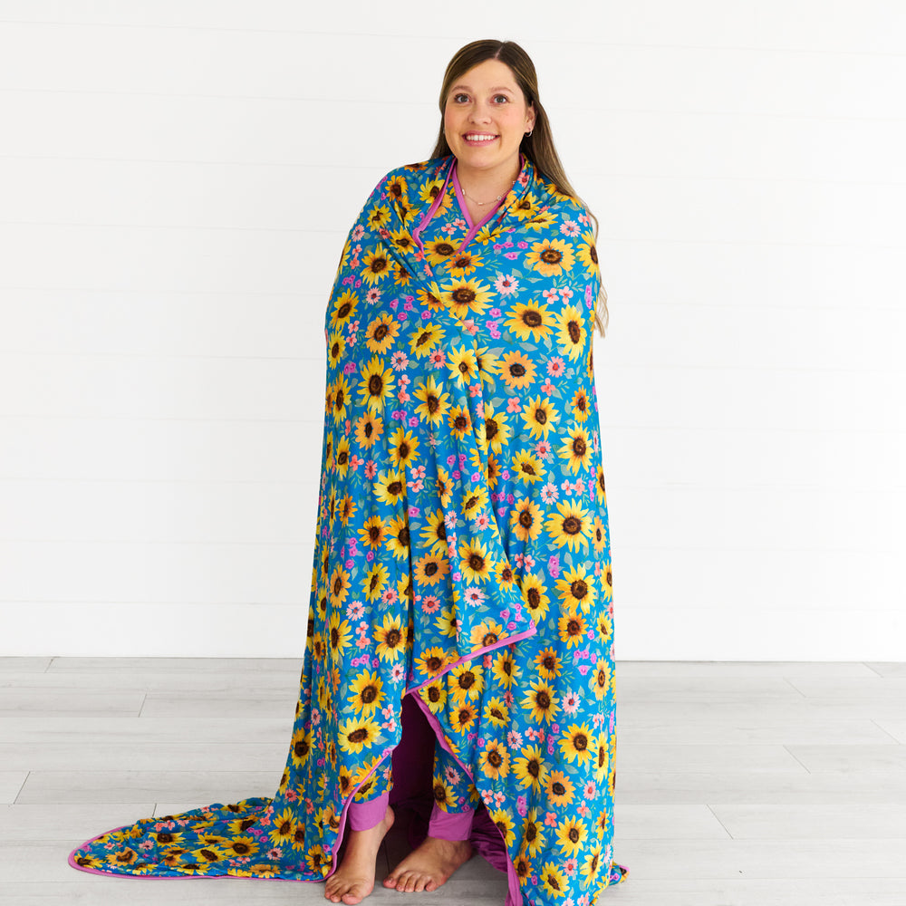 Image of woman wrapped in the Sunflower Fields Oversized Cloud Blanket®