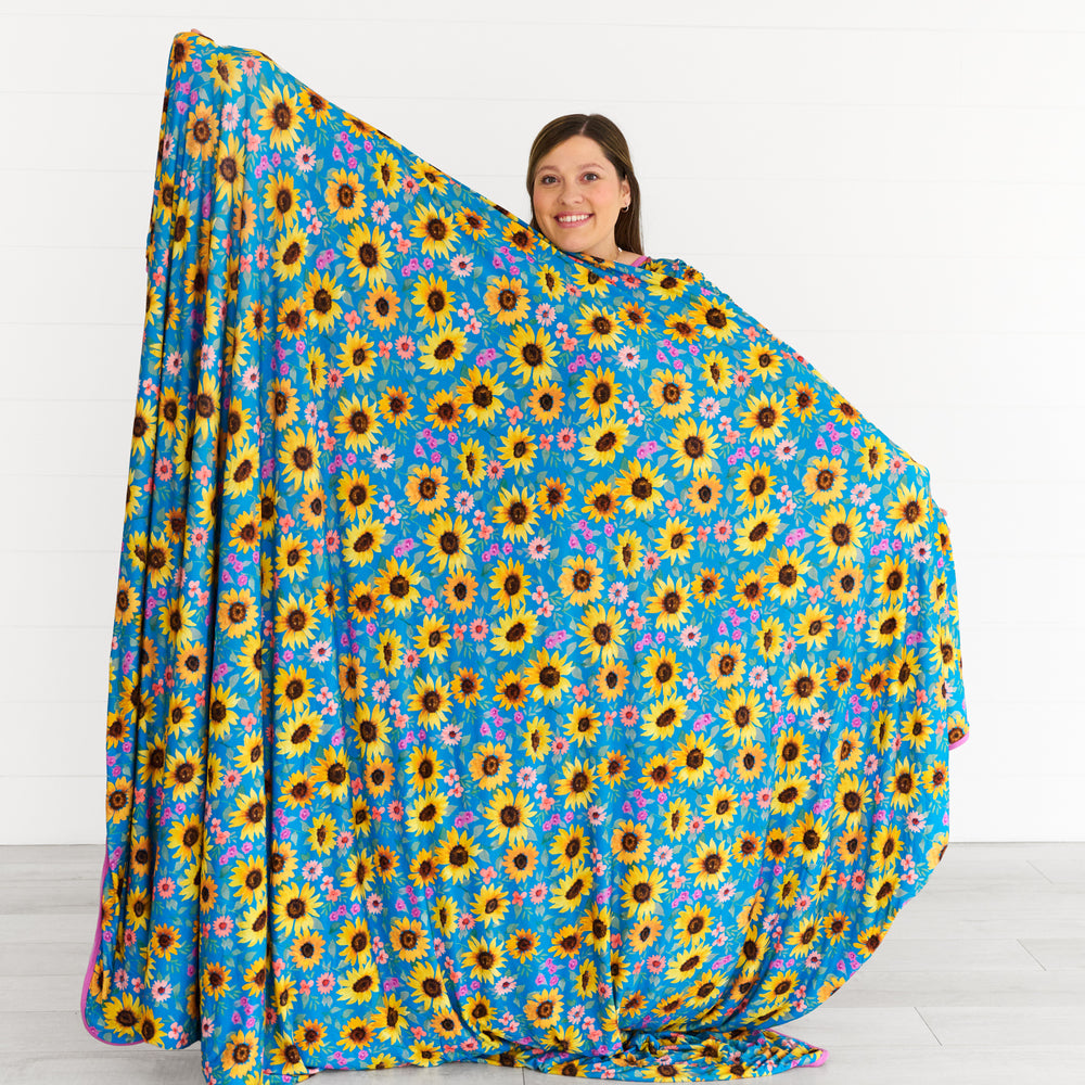 Image of woman stretching the Sunflower Fields Oversized Cloud Blanket®