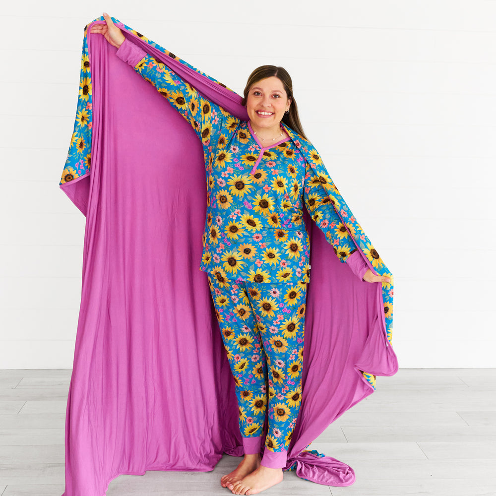 Image of woman posing with the Sunflower Fields Oversized Cloud Blanket®, displaying the inside of the blanket