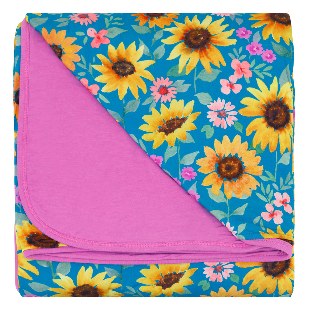 Flat lay of the Sunflower Fields Oversized Cloud Blanket® folded