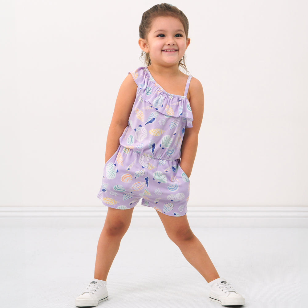 Child posing wearing a Sandy Treasures Asymmetrical romper