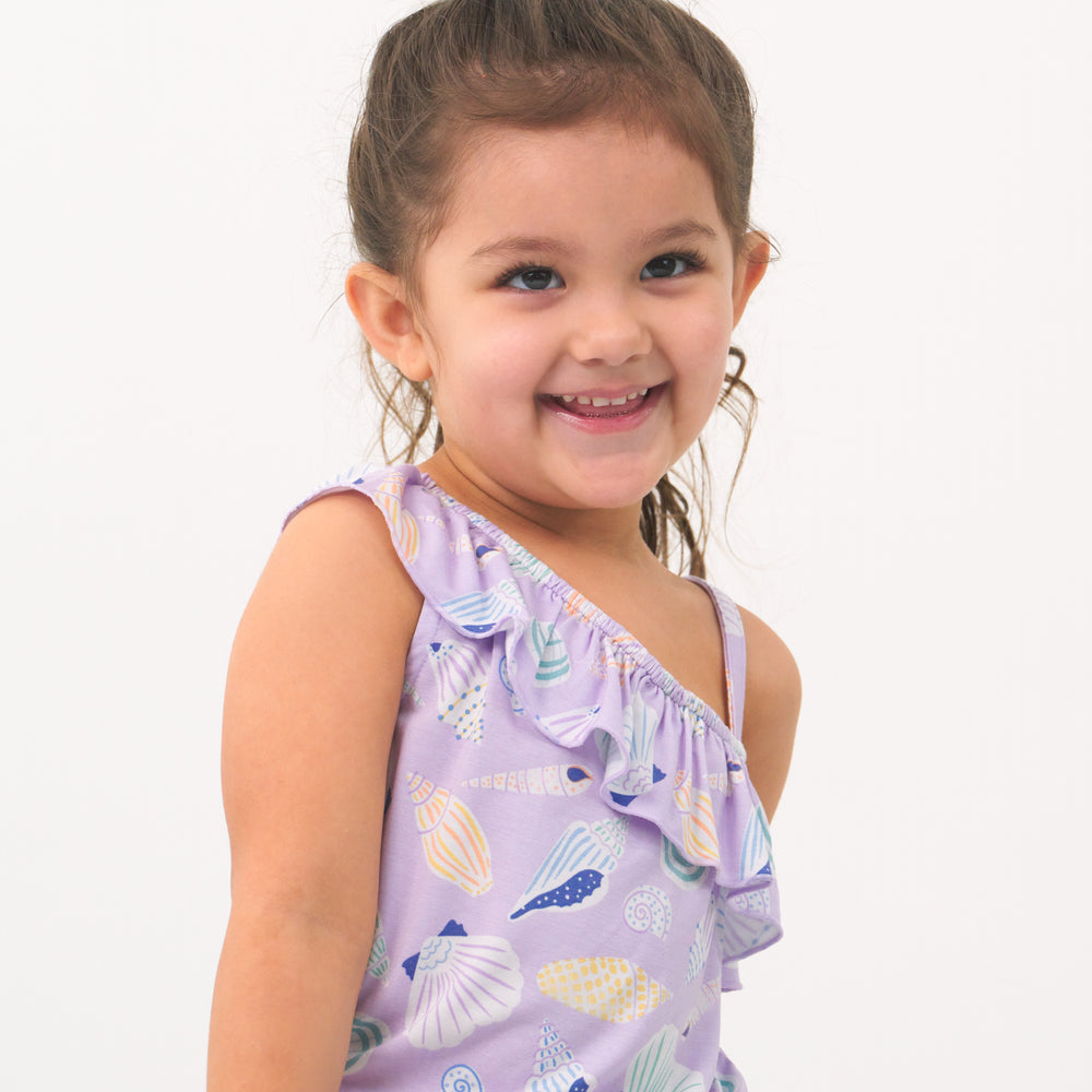 Alternate close up image of a child posing wearing a Sandy Treasures Asymmetrical romper