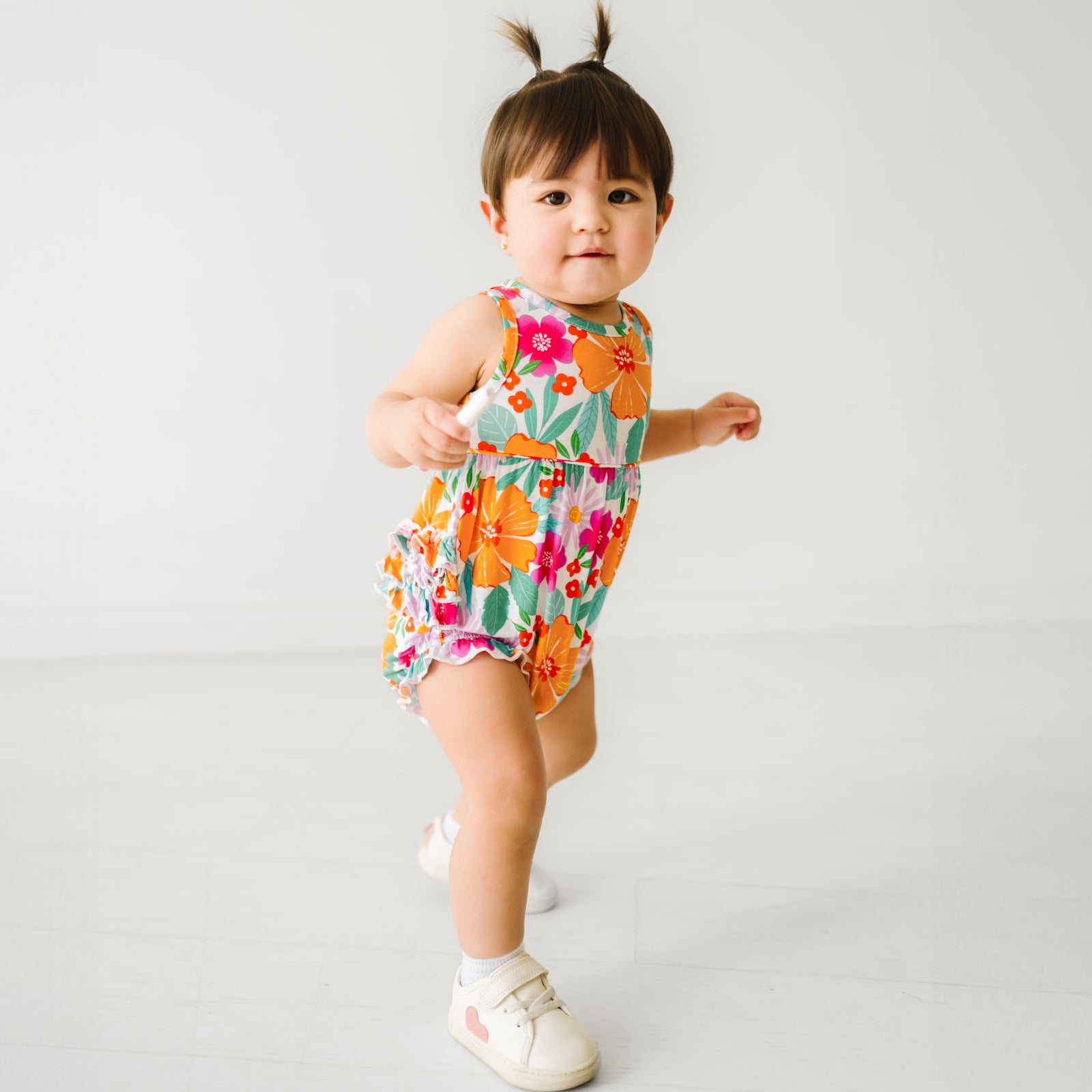 Child wearing Beachy Blooms bubble romper. 